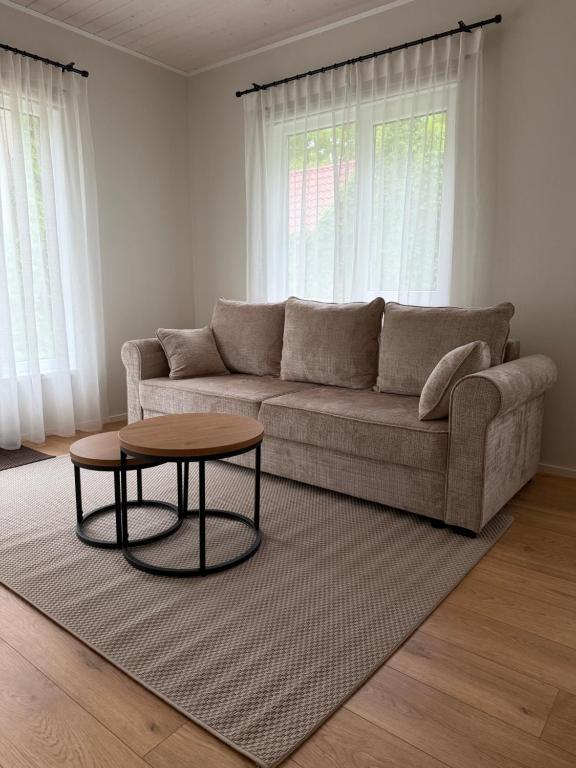 a living room with a couch and a table at Nurmeveski Holiday House in Nurme