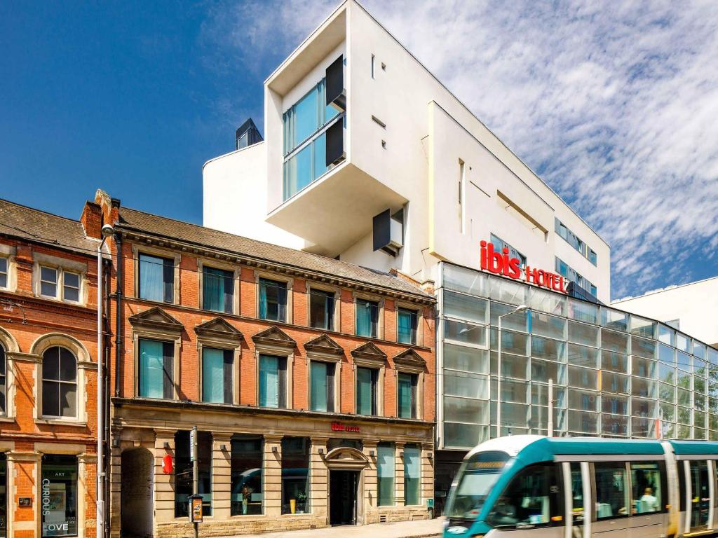 a bus is parked in front of a building at ibis Nottingham Centre in Nottingham