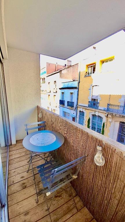 a table and chairs on a balcony with a view at BoHémian Studio in Sète Center in Sète