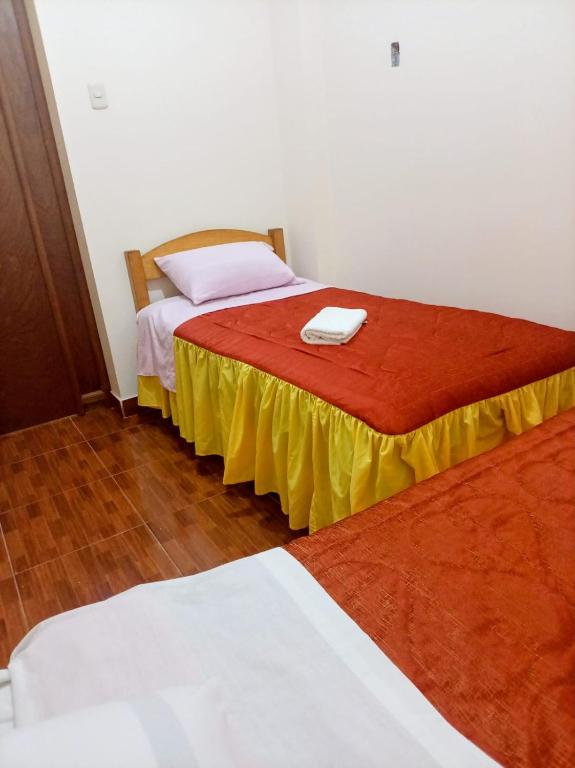 two beds sitting next to each other in a room at Perú Andina Tours & Hostel Amparo in Huaraz