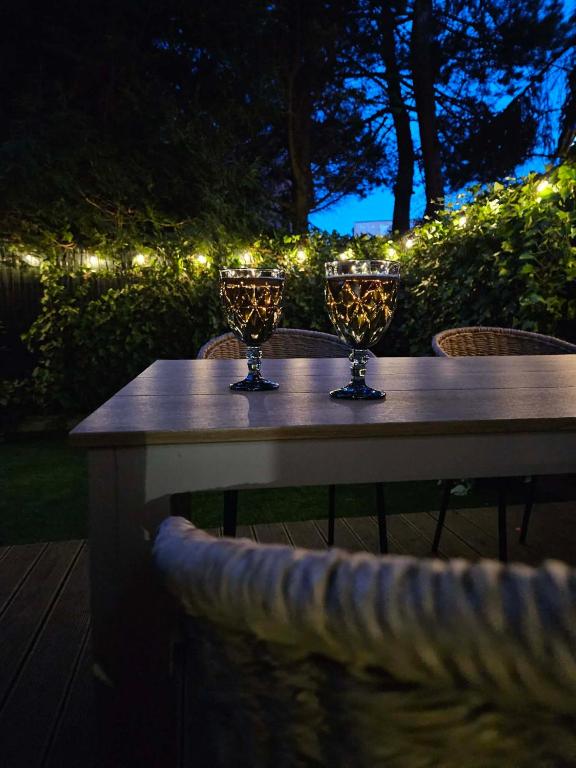 a table with two wine glasses on top of it at Apartament Przystań in Łeba