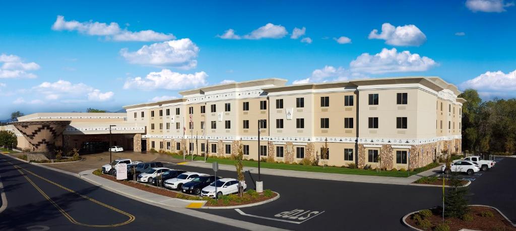 a large white building with cars parked in a parking lot at Win-River Resort and Casino in Redding