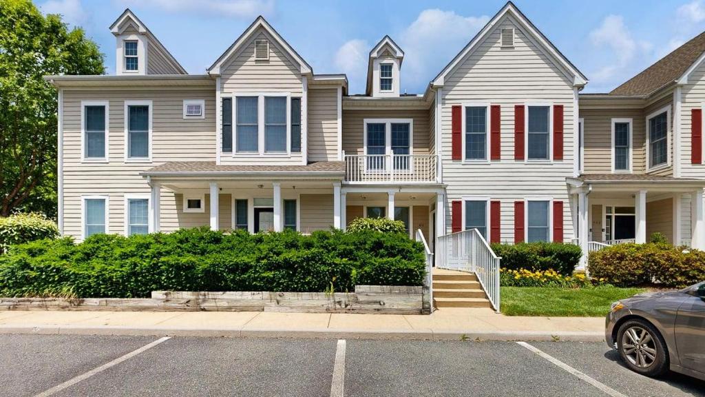 a house with a car parked in front of it at Bear Trap Dunes - 45D Willow Oak Ave in Ocean View