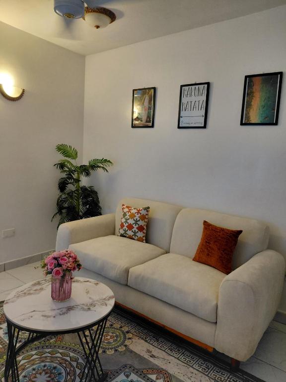 a living room with a couch and a table at Havy Homes in Bamburi
