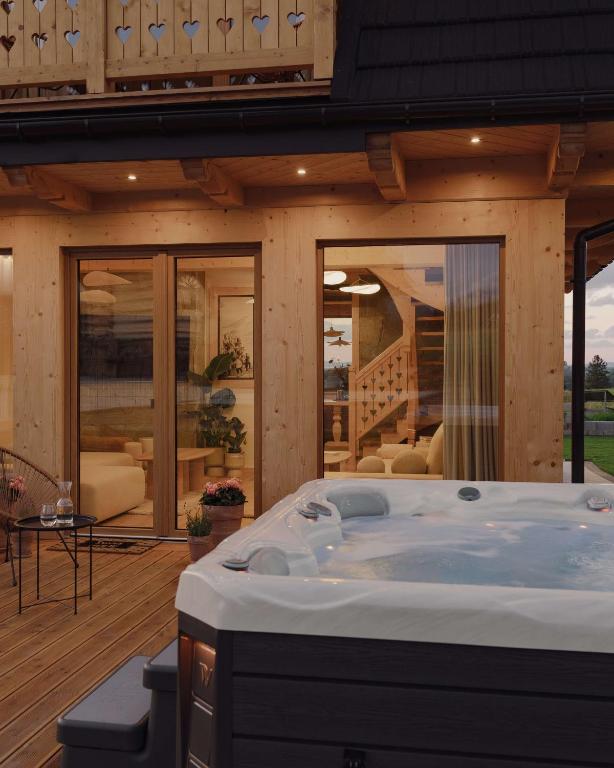 a hot tub in the middle of a house at Lovelia Luxury Chalet & Jacuzzi in Zakopane