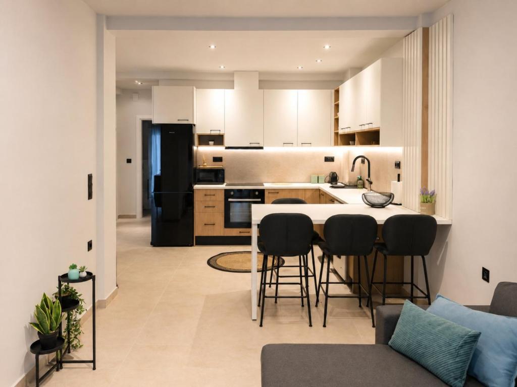 a kitchen with a large island in a living room at Aura di centro Thassos in Limenas