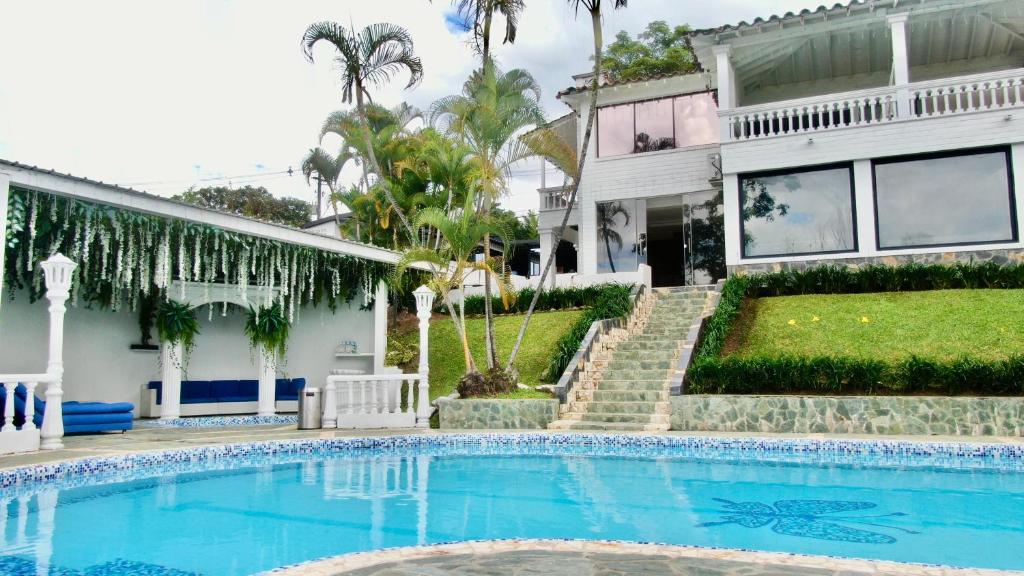 a house with a swimming pool in front of a house at The Butterfly Mansion in Envigado