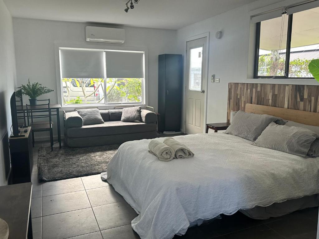 a bedroom with a bed with a towel on it at The Hunter Studio in Cessnock