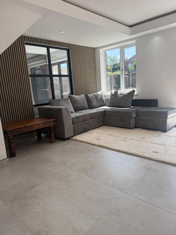 a living room with a couch and a table at The Hideaway Aylesbury in Buckinghamshire