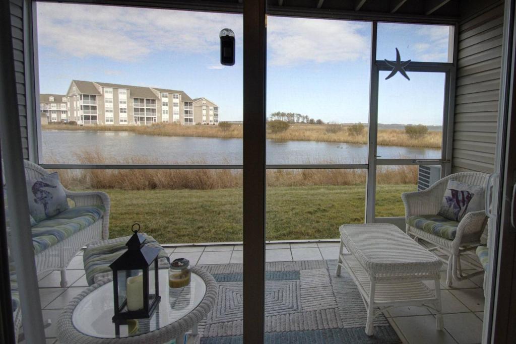 a screened in porch with a view of a lake at 30399 Pavilion Dr, #1301, Ocean View in Ocean View