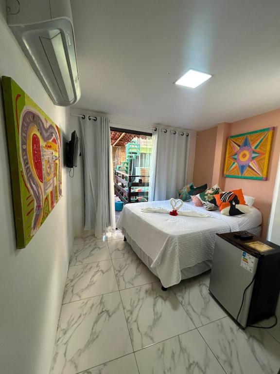 a bedroom with a bed and a window at Pousada e Restaurante Morena Raiz in Olinda