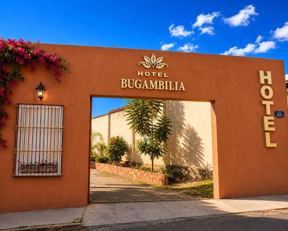 a hotel sign on the side of a building at Hotel Bugambilia in Zimapán