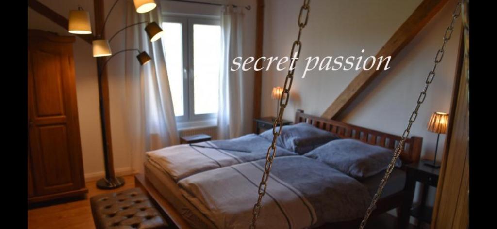 a bedroom with a swing bed in a room at Romantisches SM Apartment Secret Passion in Fehmarn