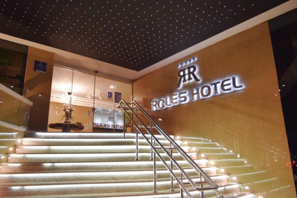 a set of stairs in a building with a hotel sign at ROLES Hotel in Sucre