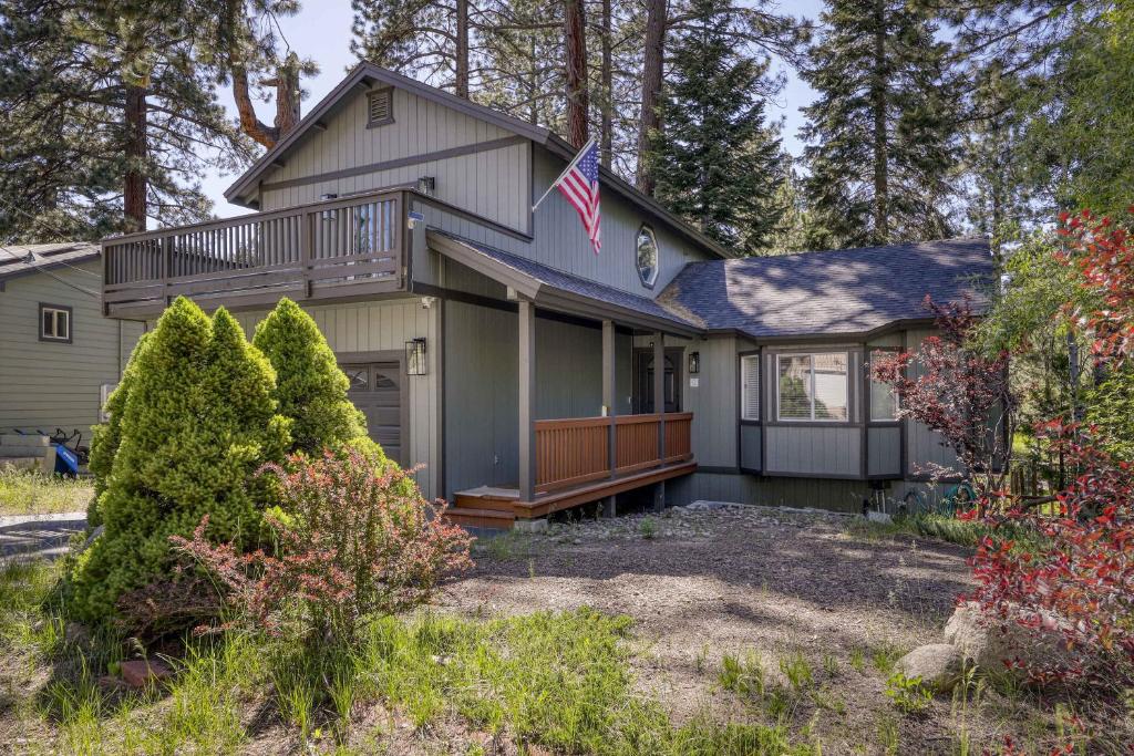 a house with a porch and an american flag at Tahoe Forest Haven in South Lake Tahoe