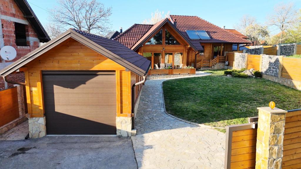 a garage in the driveway of a house at Violetta Cottage in Užice