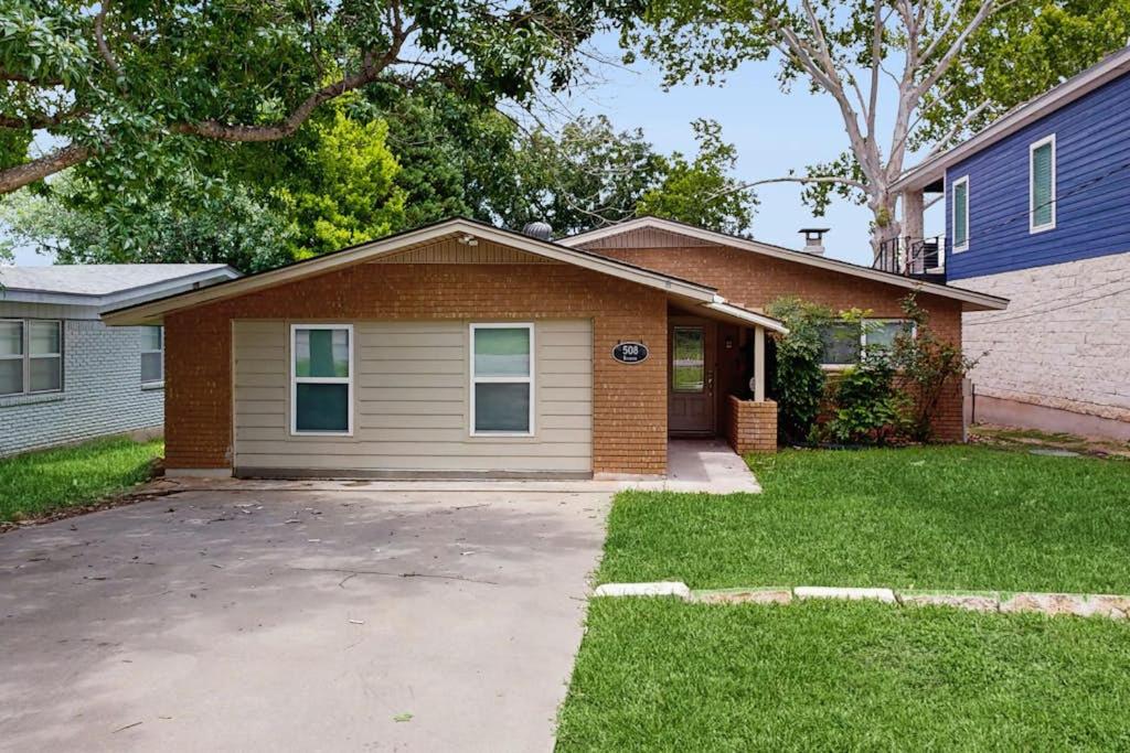 a house with a driveway in front of it at Dog-Friendly Lakefront Home with Private Sundeck in Kingsland