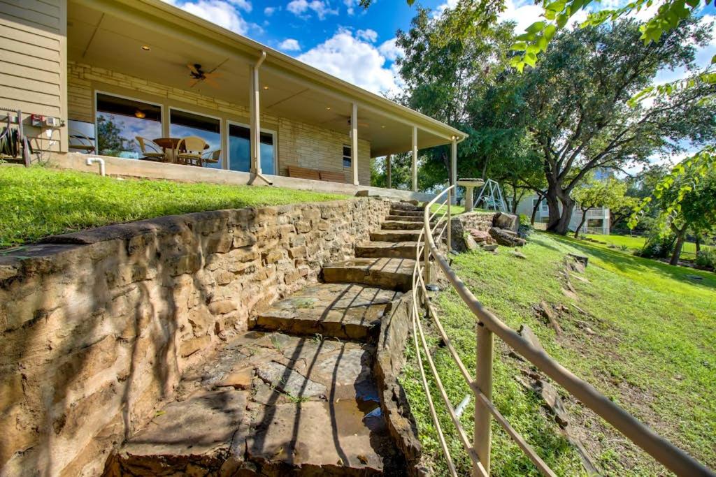 a stone retaining wall in front of a house at Renovated Waterfront Home with WiFi, Lake Views, Dock & Boat Lift - Dogs OK in Buchanan Dam