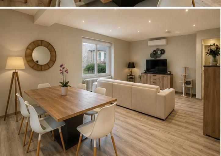 a living room with a table and a couch at Maison de vacances in Capdenac-Gare