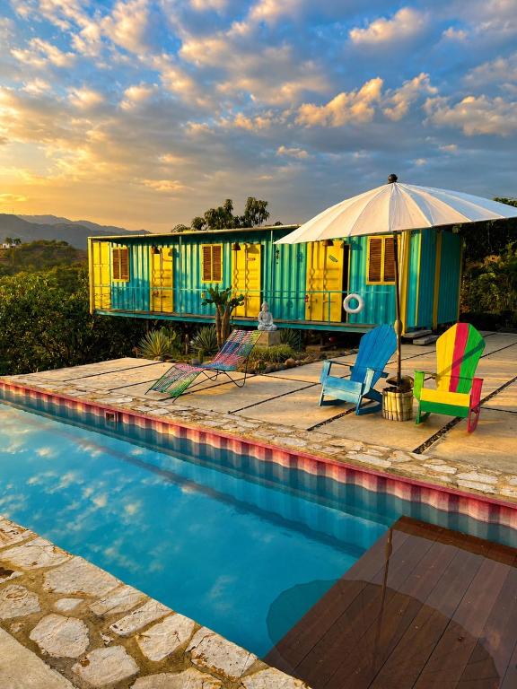 a house with a swimming pool and an umbrella at Casa campestre Namaste Entre La Mesa y Anapoima con piscina privada in La Mesa