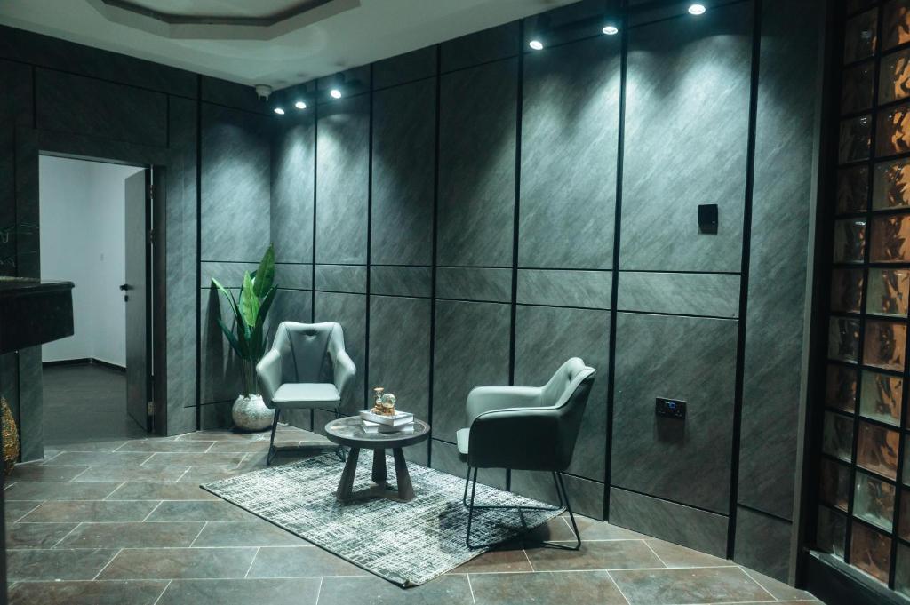 a room with two chairs and a table at Muster Point Hotel & Suites in Port Harcourt