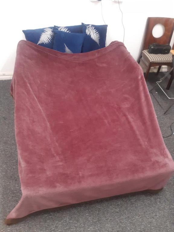 a pink blanket sitting on top of a couch at Vincente's in Chatham