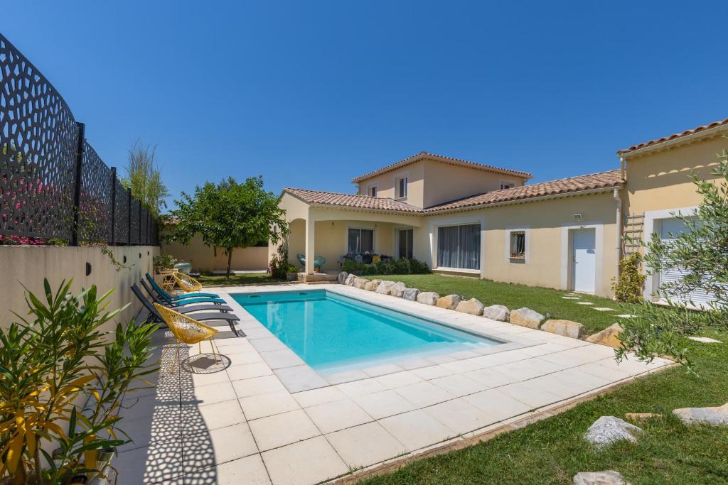 a swimming pool in the backyard of a house at Olympe de Provence in Caromb