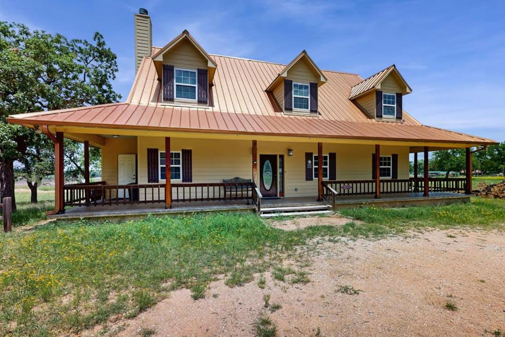 a house with a large porch with a roof at Waterfront Home with Kayak, View, Fire Pit & WiFi - Dog-Friendly in Buchanan Dam