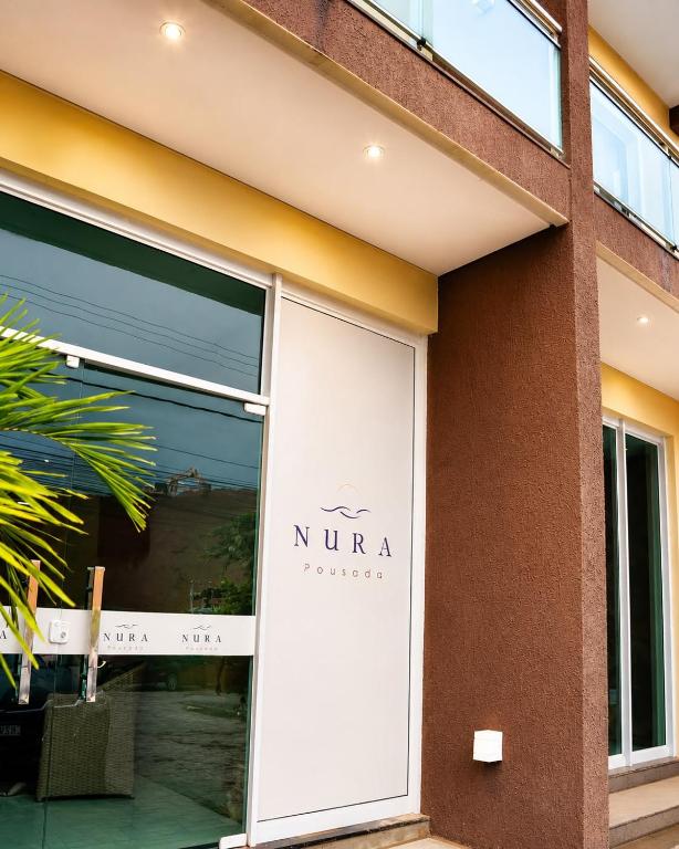 a nirvana sign on the side of a building at Nura Pousada in Maragogi