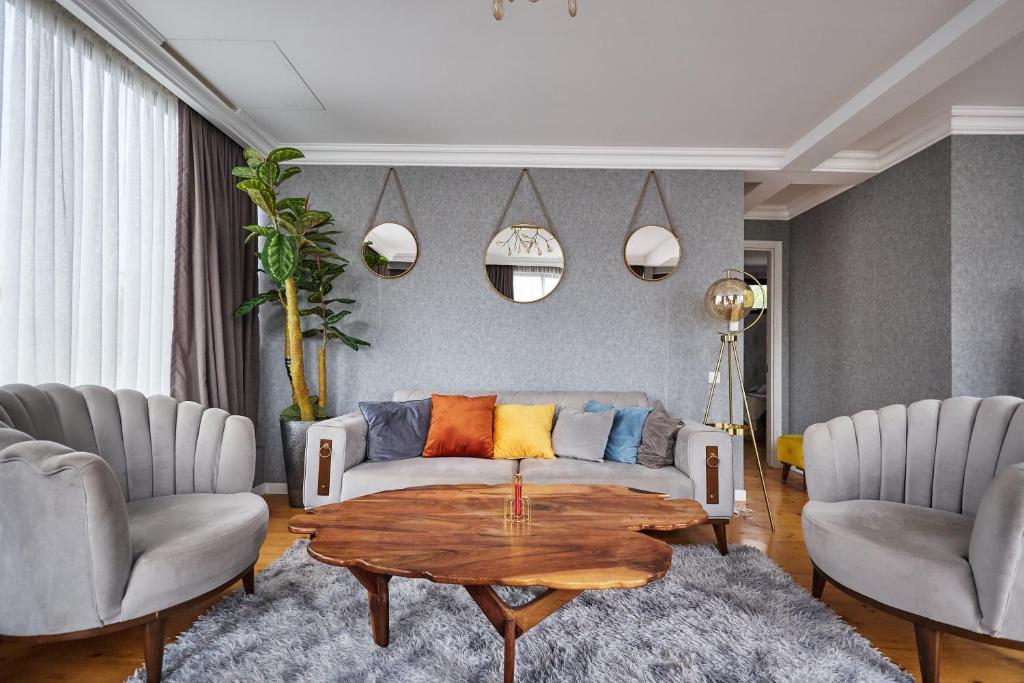 a living room with a couch and a table at 4Season Villa in Tbilisi City