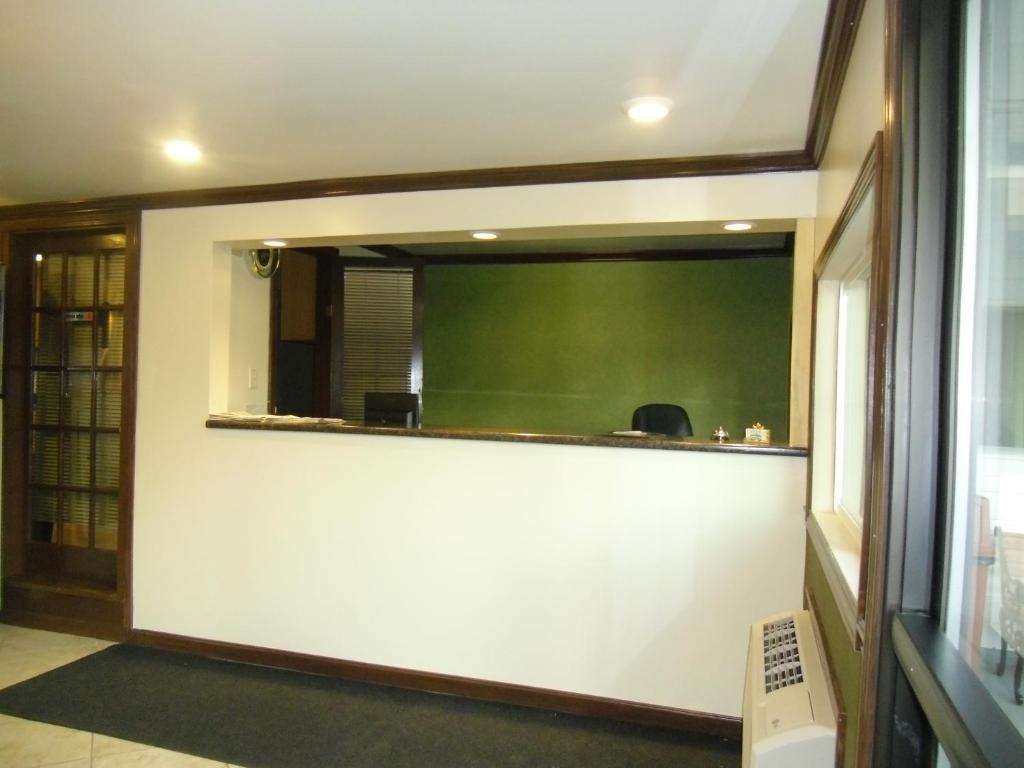 a meeting room with a large window and a green screen at Pilgrim Inn & Cottages in Plymouth