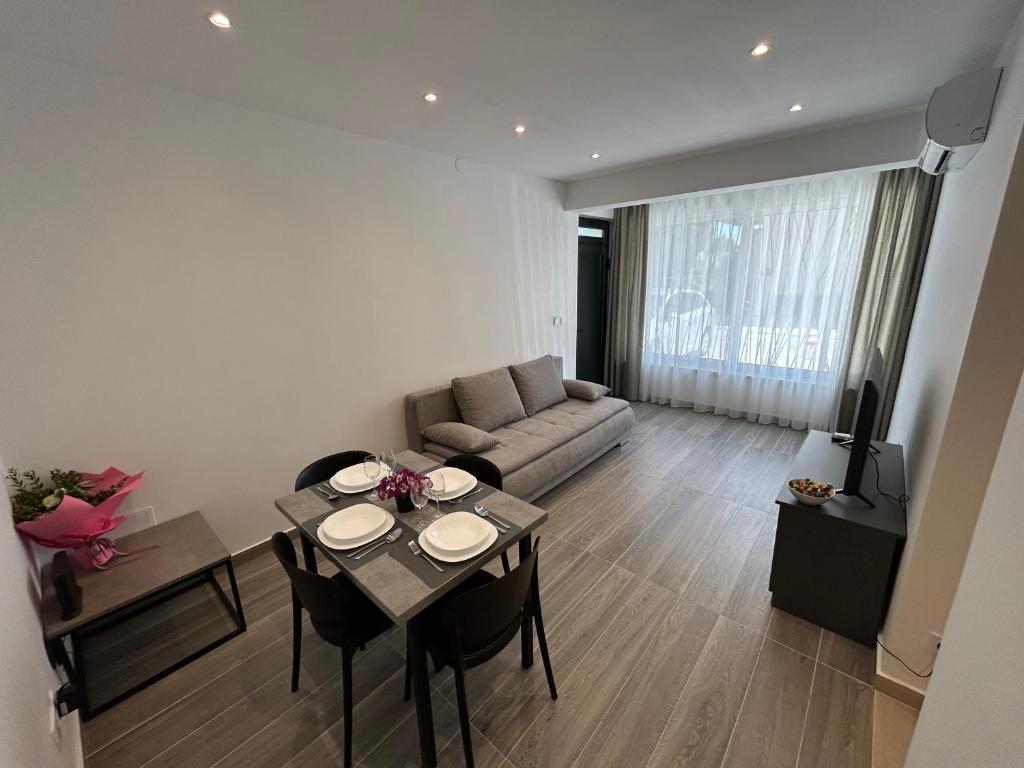 a living room with a couch and a table and chairs at Makala Accommodation in Split