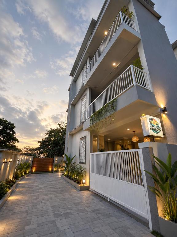 a house with a balcony with lights on it at Jimbaran Hostel Bali in Jimbaran
