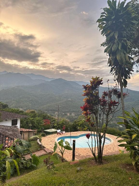 a view of a swimming pool with mountains in the background at La Villa The View in Pance