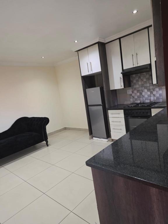 a kitchen with a black counter top in a room at Mafjoint6 in eMalahleni