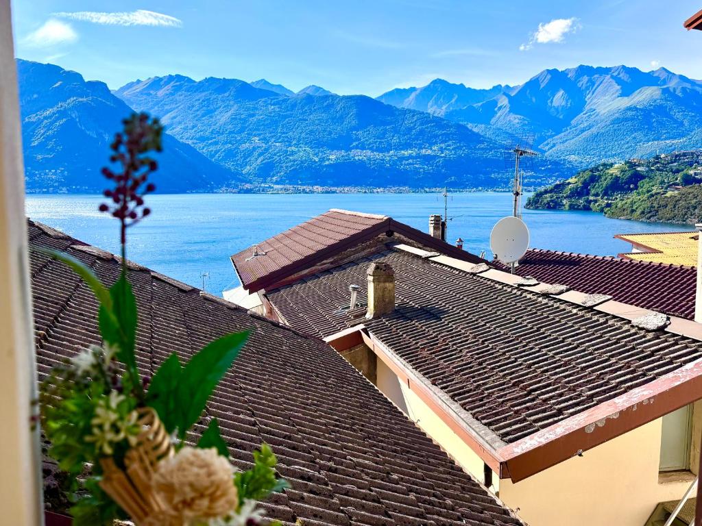 a view of a lake from the roofs of houses at Piccolo Borgo vista lago di Como by Gottschalk in Dorio