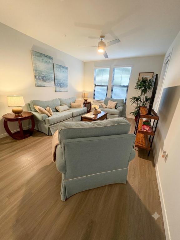 a living room with two couches and a table at Coastal Life at Aqua in Bradenton