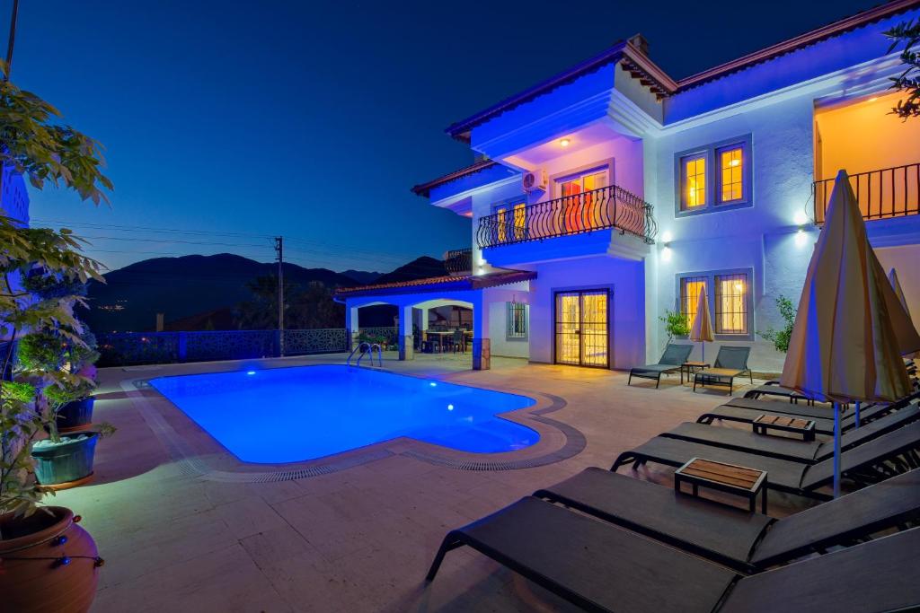 a villa with a swimming pool at night at Villa Ahad in Fethiye