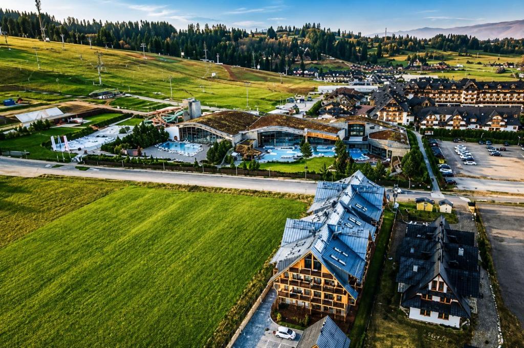 an aerial view of a town with a large building at Apartament Stary Drewniany Białka Ski Resort -obok Termy Bania i Kotelnica in Białka Tatrzańska