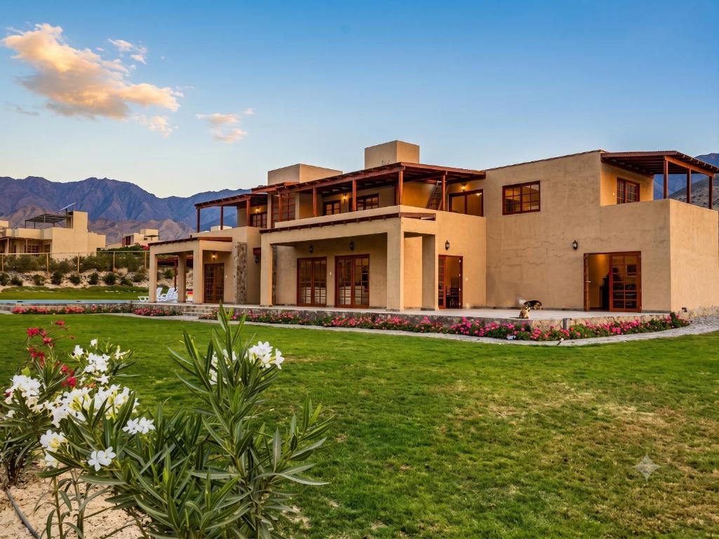 a large house with a lawn in front of it at Cieneguilla Eco House in Cieneguilla