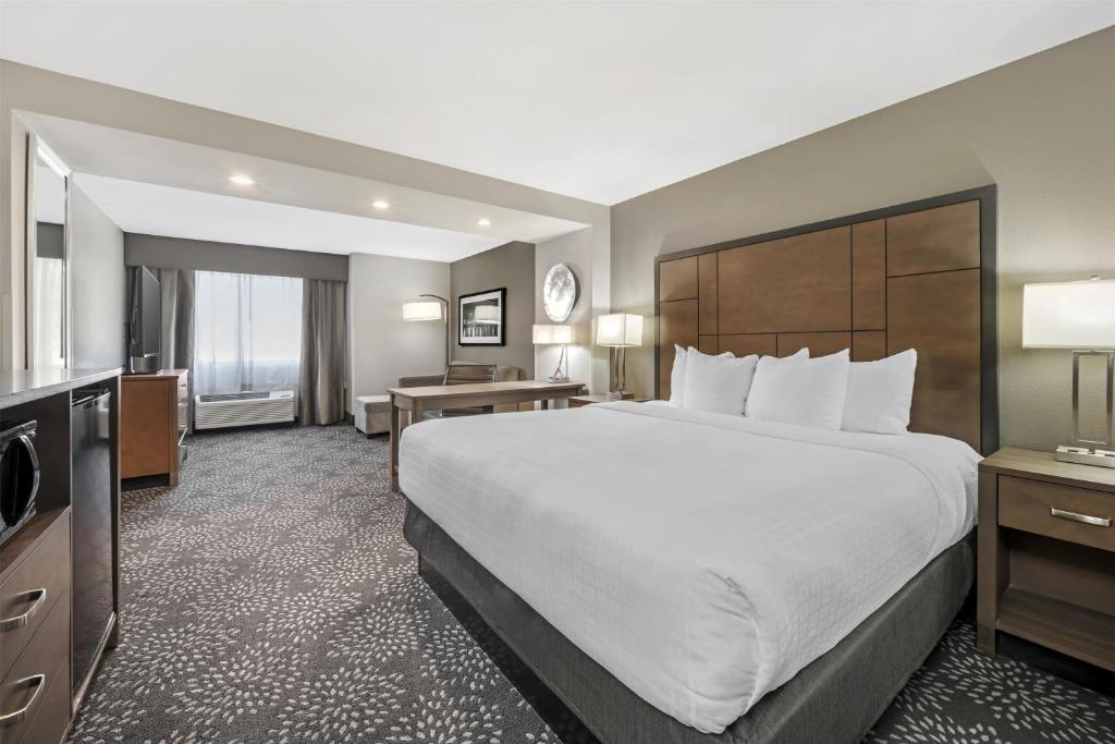 a hotel room with a large bed and a desk at Best Western Plus Spokane North in Spokane