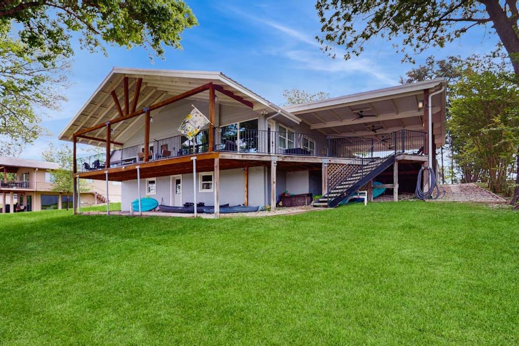 a large house with a porch and a playground at Waterfront Home with Kayaks, Game Room, Firepit, & Enormous Deck in Kingsland