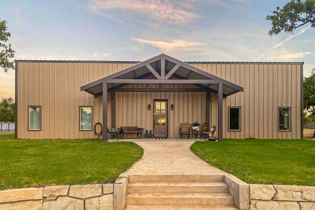 a large building with a porch and a patio at Expansive Getaway Near Downtown with Fast WiFi, Grill in Fredericksburg