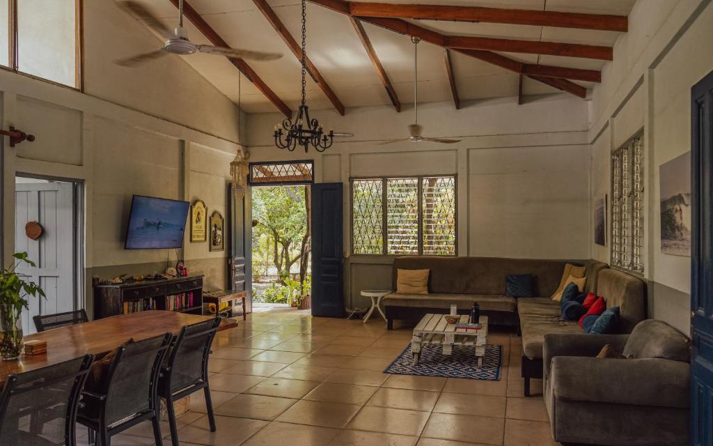 a living room with a couch and a table at Hostel Nosara in Playa Guiones