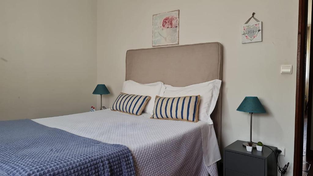 a bedroom with a large bed with two pillows at Barra's Beach Apartment in Praia da Barra