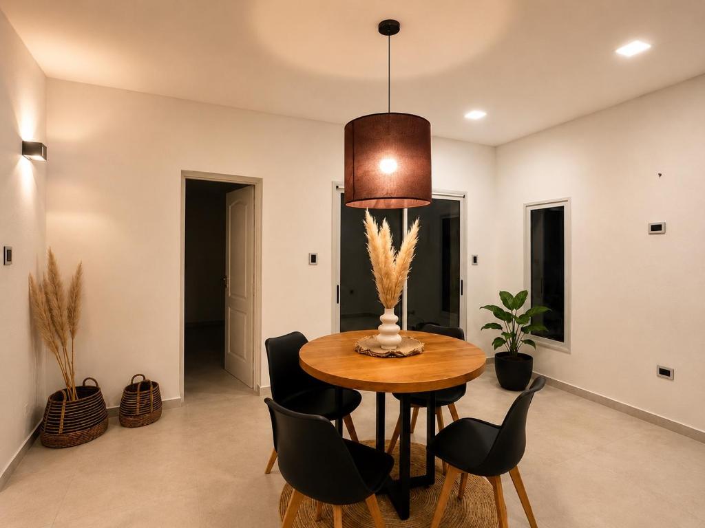 a dining room with a wooden table and black chairs at Departamento Parque, Asador y Pileta Privada, uso exclusivo in San Luis