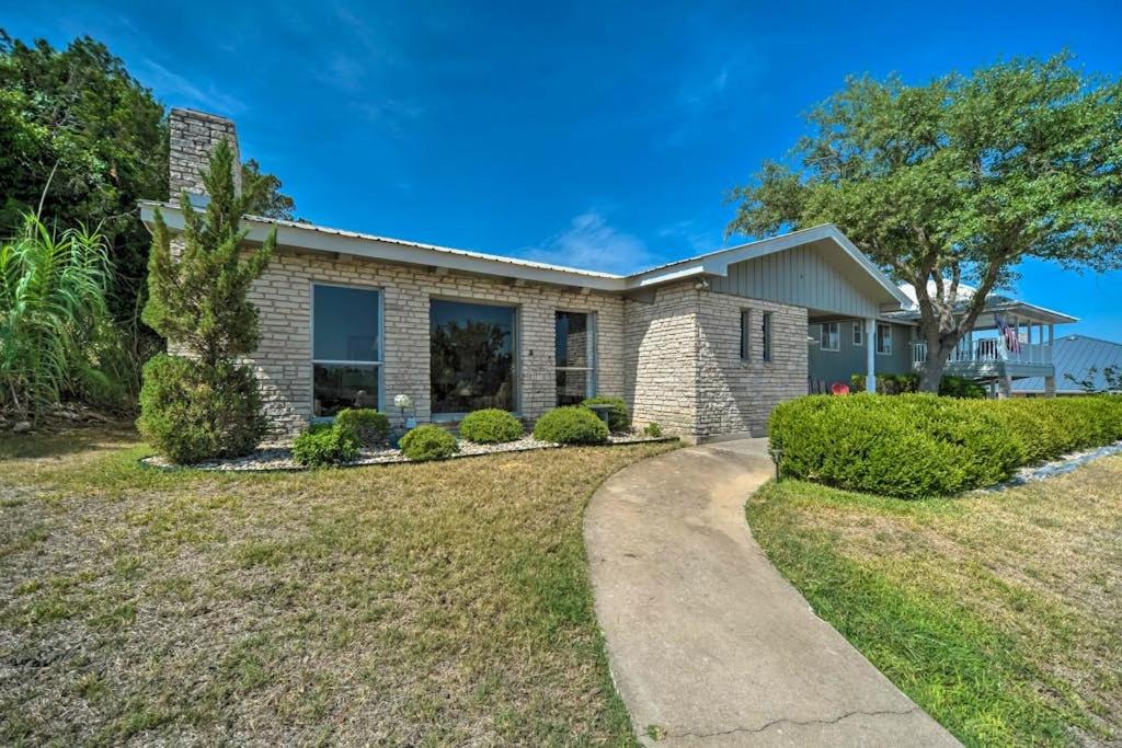 a brick house with a driveway at Snowbird-Friendly House with Game Room, Full Kitchen, Balcony & W/D in Kerrville