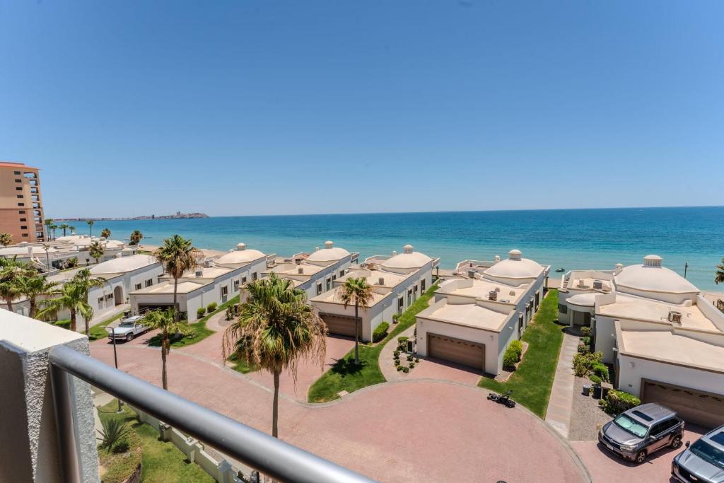 a view of the beach from the balcony of a building at Las Palmas Resort in Puerto Peñasco