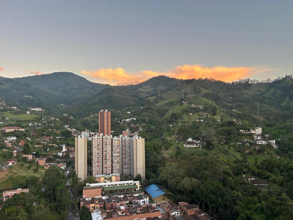 a view of a city with buildings and mountains at Atardeceres de Sabaneta in Sabaneta