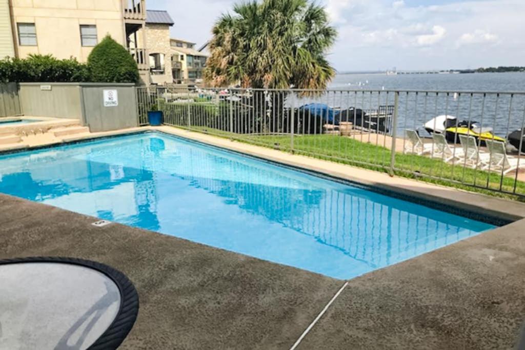 a swimming pool with a view of the water at Contemporary, Dog-Friendly Townhouse with Balcony, Pool & Day Docks in Horseshoe Bay